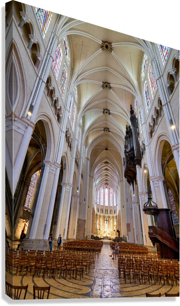 Chartres Cathedral inside with tall arches and wooden chairs Canvas Print