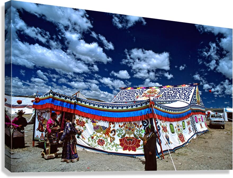 Colorful Tibetan tent with people under a cloudy sky in Tibet Canvas Print