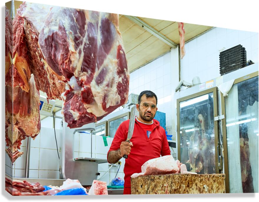 Butcher works with meat in a shop in Dubai UAE Canvas Print