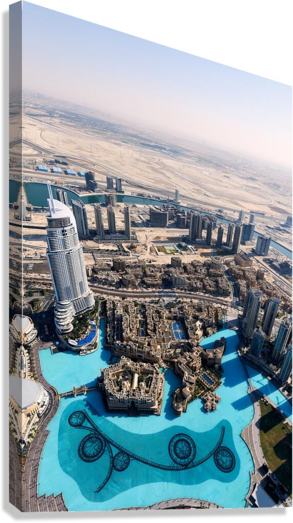 Dubai cityscape shows buildings water and desert from above Canvas Print