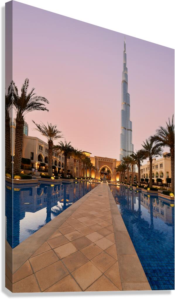 Burj Khalifa towers over pool and traditional buildings in Dubai Canvas Print