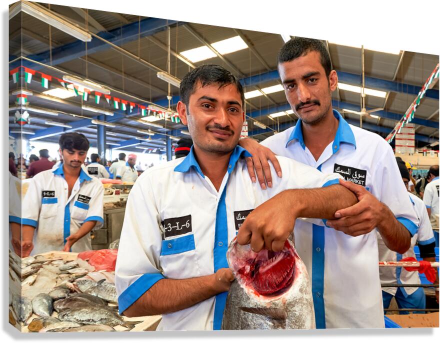Fishmongers show fresh catch at market in Dubai UAE Canvas Print