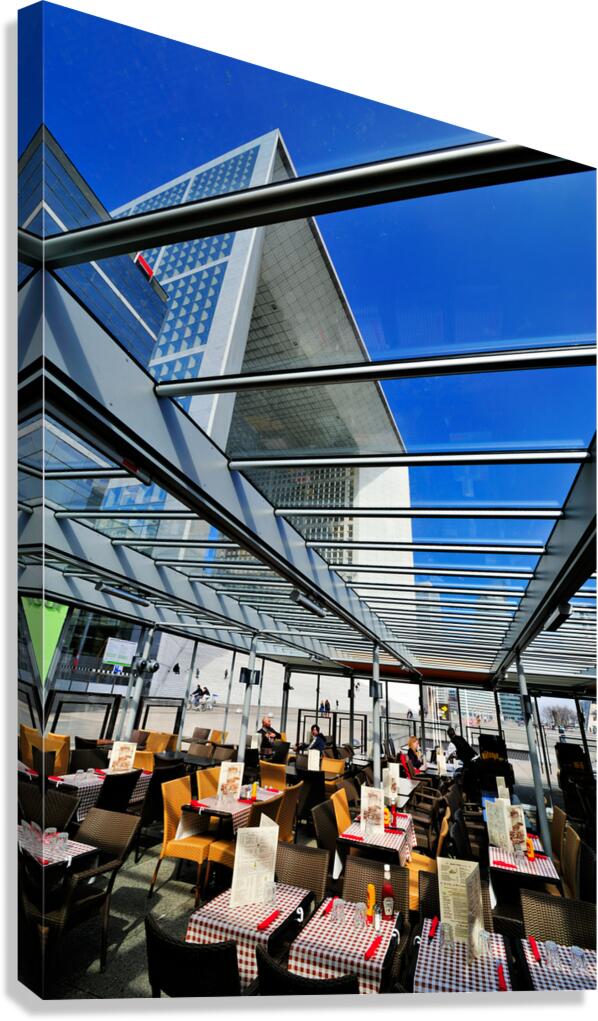 Dining area in Paris with modern building under clear sky Canvas Print