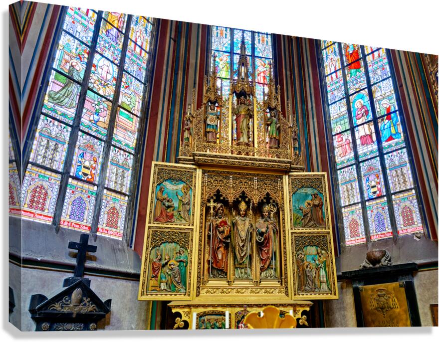 Ornate golden altarpiece and vibrant stained glass windows in a  Canvas Print
