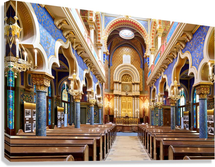 Grand ornate synagogue interior featuring golden ark and pews. Canvas Print