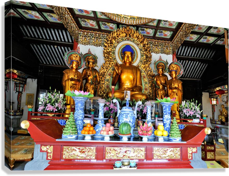 Visitors observe golden statues in Shanghai Buddhist temple inte Canvas Print