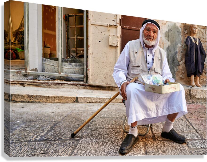 Old man sits in the old city of Jerusalem asking for help Canvas Print