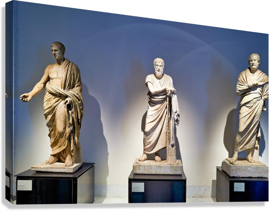 Statues of ancient philosophers displayed in museum setting Canvas Print