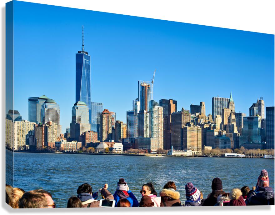 Tourists view Manhattan skyline from a boat on the water in New  Canvas Print