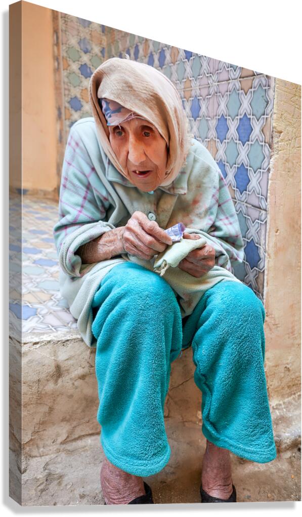 Beggar sitting in Fez Morocco with worn clothes and hands Canvas Print