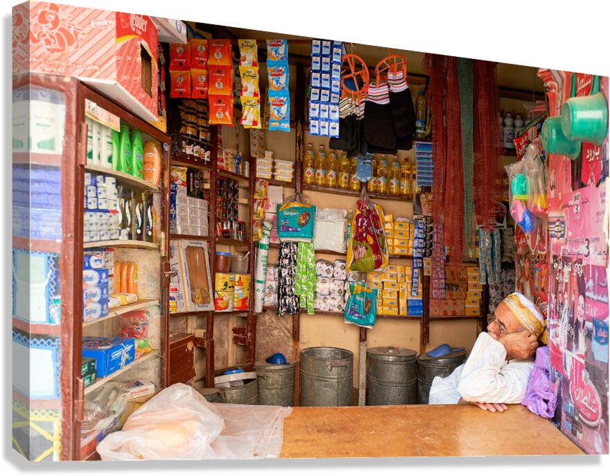 Grocer sleeping in shop in Marrakesh during afternoon hours Canvas Print