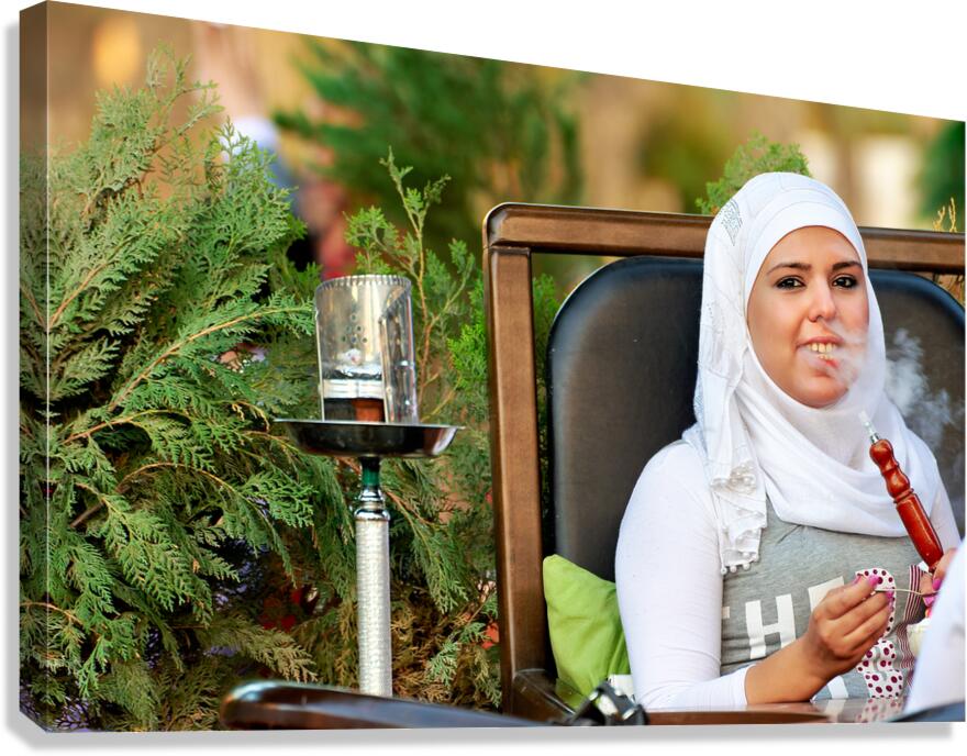 Young woman smokes hookah in outdoor cafe in Aleppo Syria Canvas Print