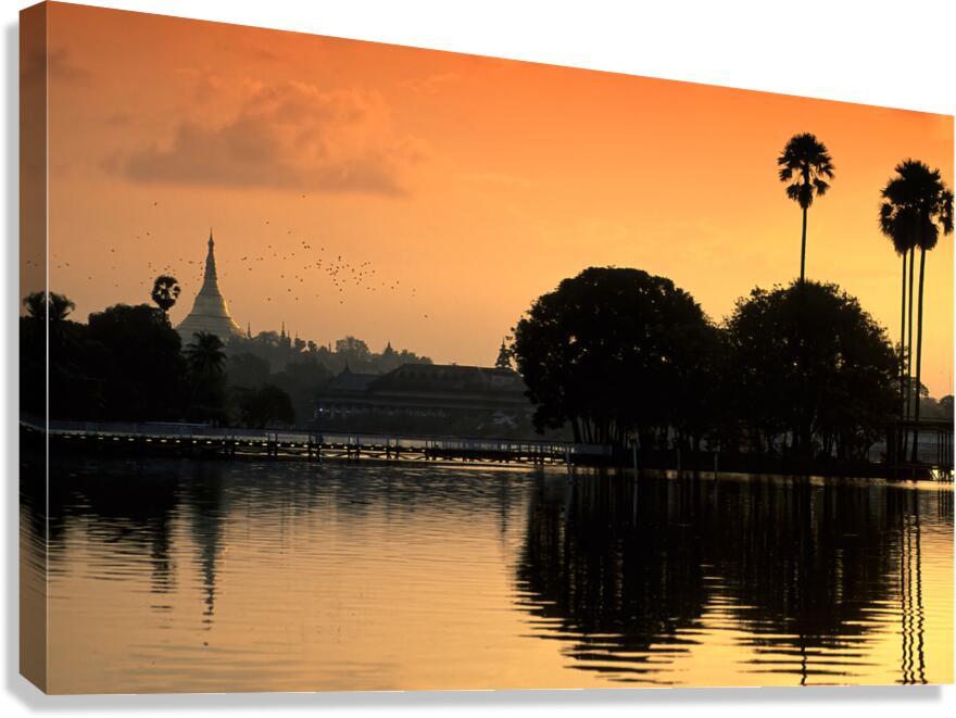 Sunset over the water in Yangon with palm trees and buildings Canvas Print