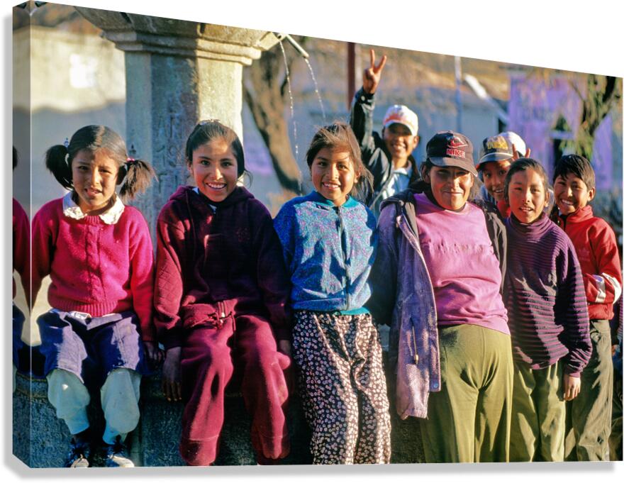 Smiling children and youth gather by a fountain. Canvas Print