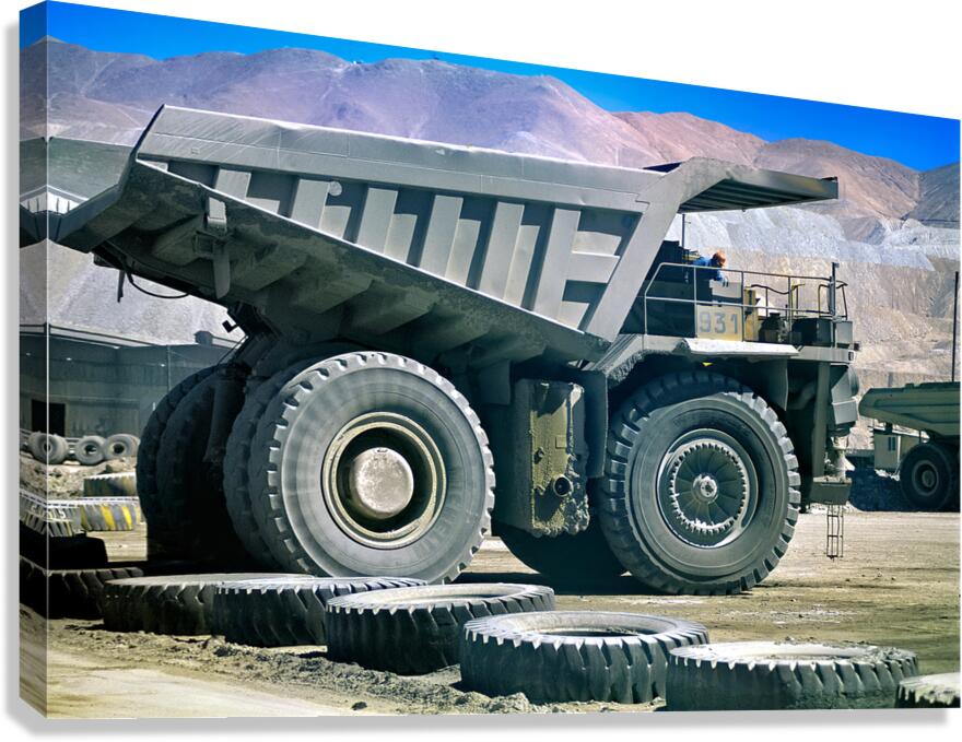 Giant mining dump truck in a dusty mountain quarry. Canvas Print