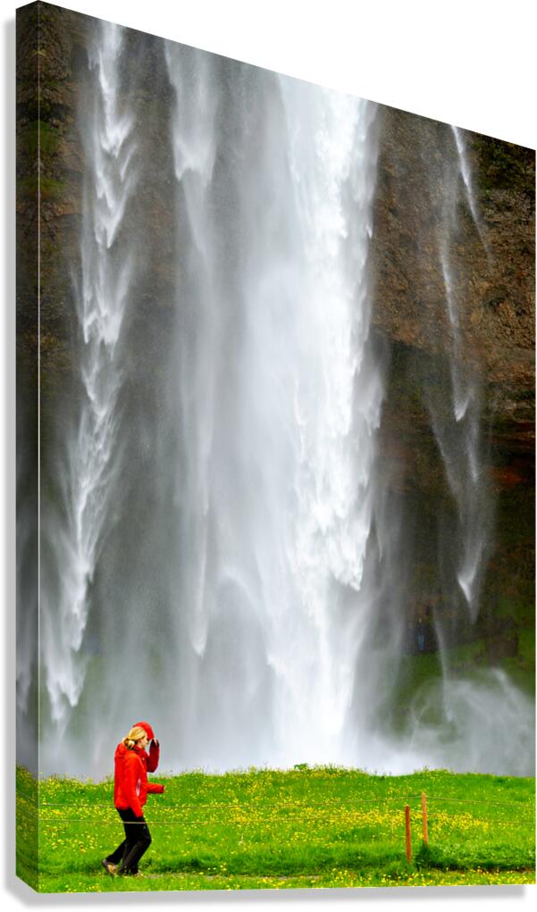 Woman walks near Seljalandsfoss waterfall in Iceland Canvas Print