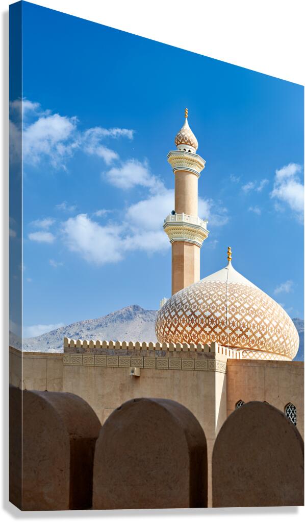 Nizwa Fort shows mosque and tower with blue sky and clouds Canvas Print