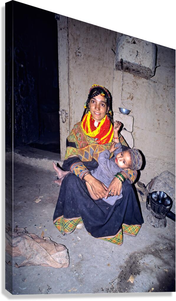A woman holds her child in a Kalash village Canvas Print