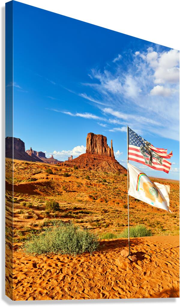 Monument Valley displays flags under blue sky in USA Canvas Print