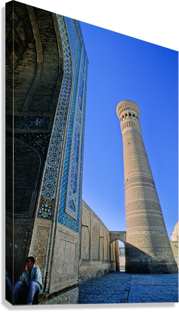 People rest near the tall minaret in Khiva Uzbekistan Canvas Print