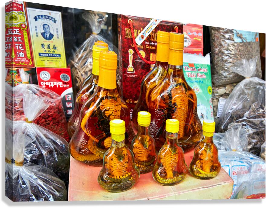 Vietnamese snake wine bottles displayed in Hanoi market Canvas Print