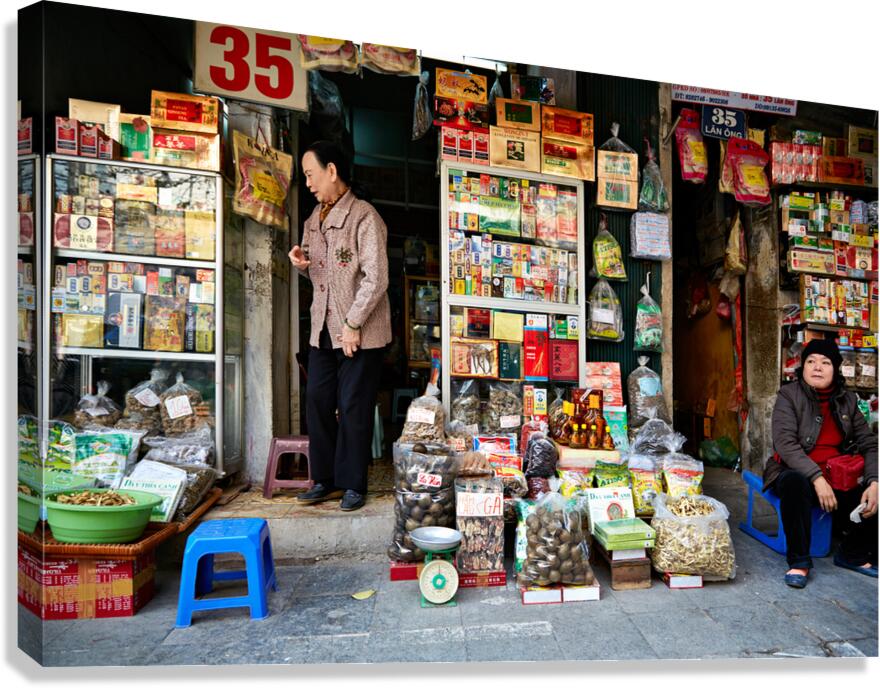 Market scene with vendors selling goods in Hanoi Canvas Print