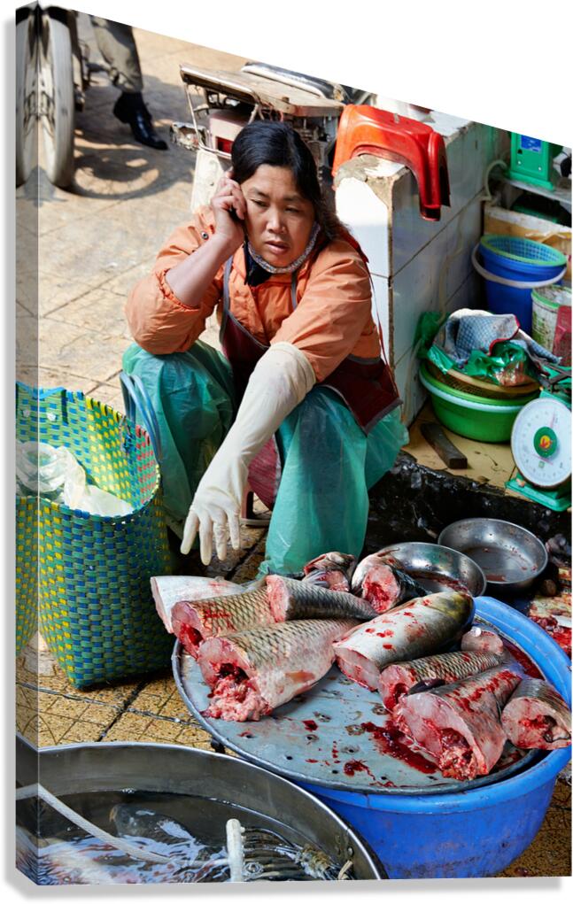 Fish vendor works at market in Hanoi Vietnam Canvas Print