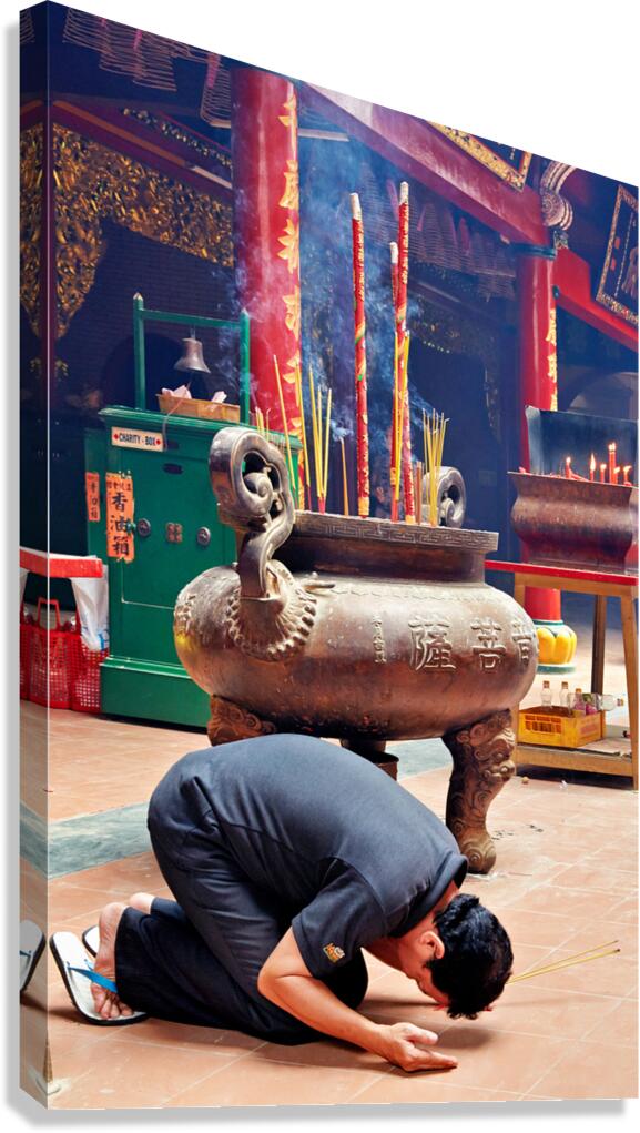 Man praying at a shrine in Ho Chi Minh City Vietnam Canvas Print