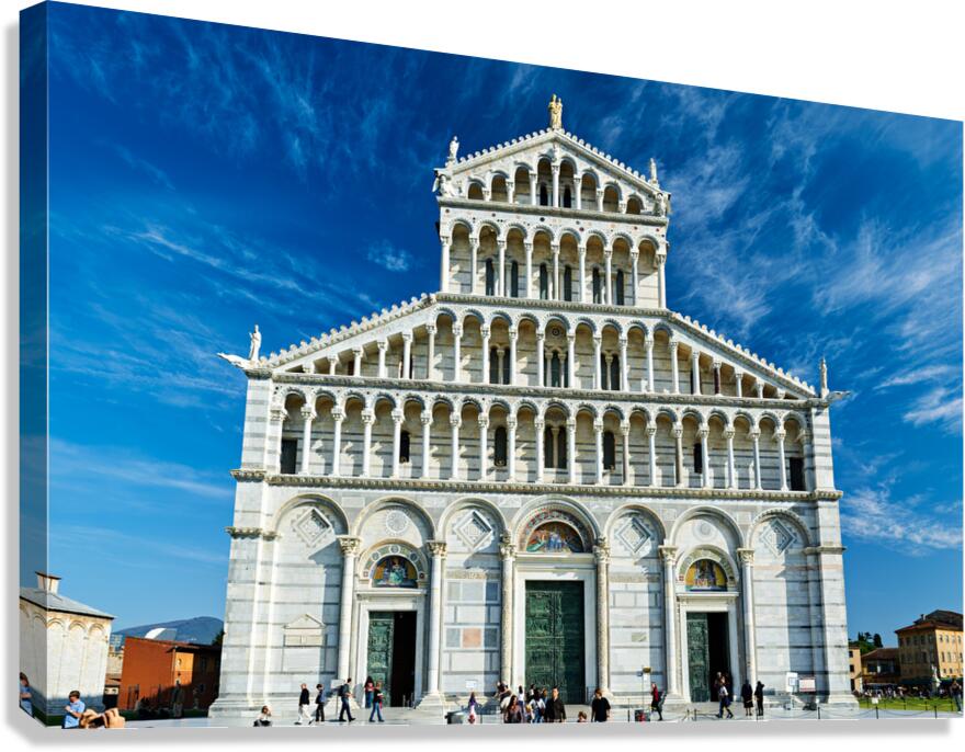Visitors walk around Pisa Cathedral in Piazza dei Miracoli. The tall structure stands under a blue sky. People enjoy the lively atmosphere. Canvas Print