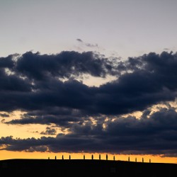 Sunset in Val dOrcia with cypresses in the background