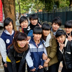 A group of young girls smiles and poses together in Hanoi