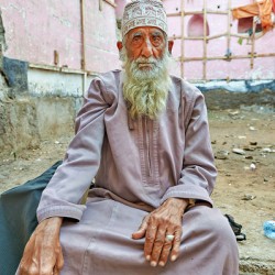 Old man sitting in a historical site in Muscat Oman