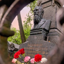 People visit the grave of Fyodor Dostoevsky in Tikhvin cemetery