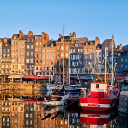 Sunrise at Honfleur harbour in Normandy France with reflections