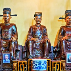Wooden statues in Hanois cultural shrine showing local history