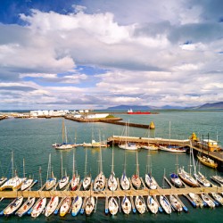Harbor view in Reykjavik Iceland with sailing boats and clouds
