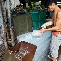 Ice cutting at a market in Ho Chi Minh City Vietnam