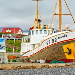 Visit to Hofn harbor in Iceland with fishing boat and sign