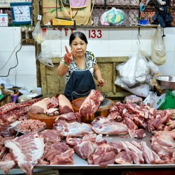 Market scene in Ho Chi Minh City with meat vendor
