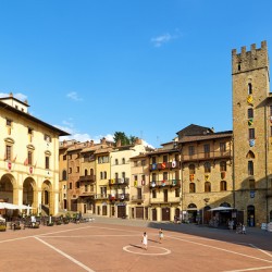 People walk through Piazza Grande in Arezzo Tuscany Italy
