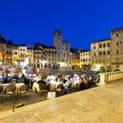 Piazza Grande at sunset offers dining and socializing in Arezzo