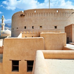 Visitors explore Nizwa Fort a historic site in Oman