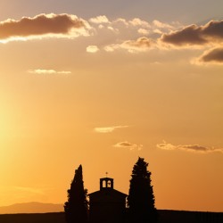Walking toward Chapel Vitaleta at sunset in Tuscany