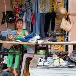 Sewing clothes at a market stall in Phu Quoc Vietnam