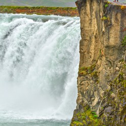 People standing near Godafoss waterfall in Iceland