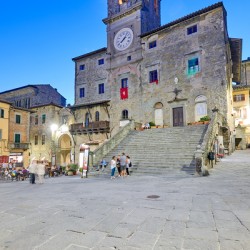 Exploring Palazzo del Popolo in Cortona Italy during sunset