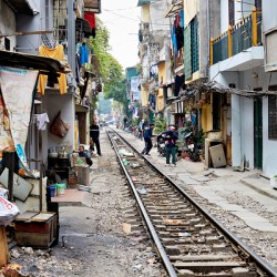 People walk along railway tracks in Ho Chi Minh City Vietnam
