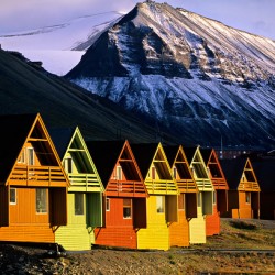 Colorful cabins in Longyearbyen Svalbard near snowy mountains