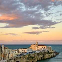 Vieste Gargano. Apulia Puglia Italy. Cape San Francesco and San Francesco church at sunset