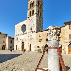Bevagna Umbria Italy. San Michele Arcangelo church and roman column in San Silvestro square